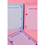 Pinkie Skies Studio Bloom Task Tracker Notepad featuring a trio of colorful designs for organized planning.
